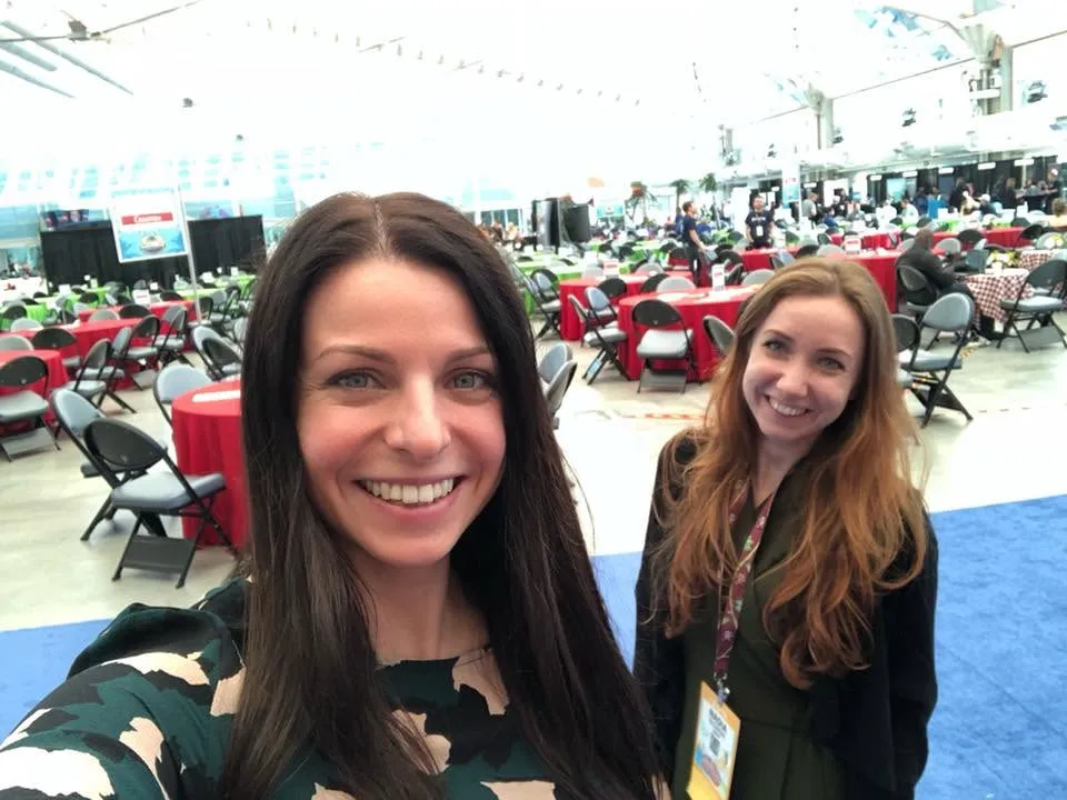 Nadia with a colleague in a convention hall
