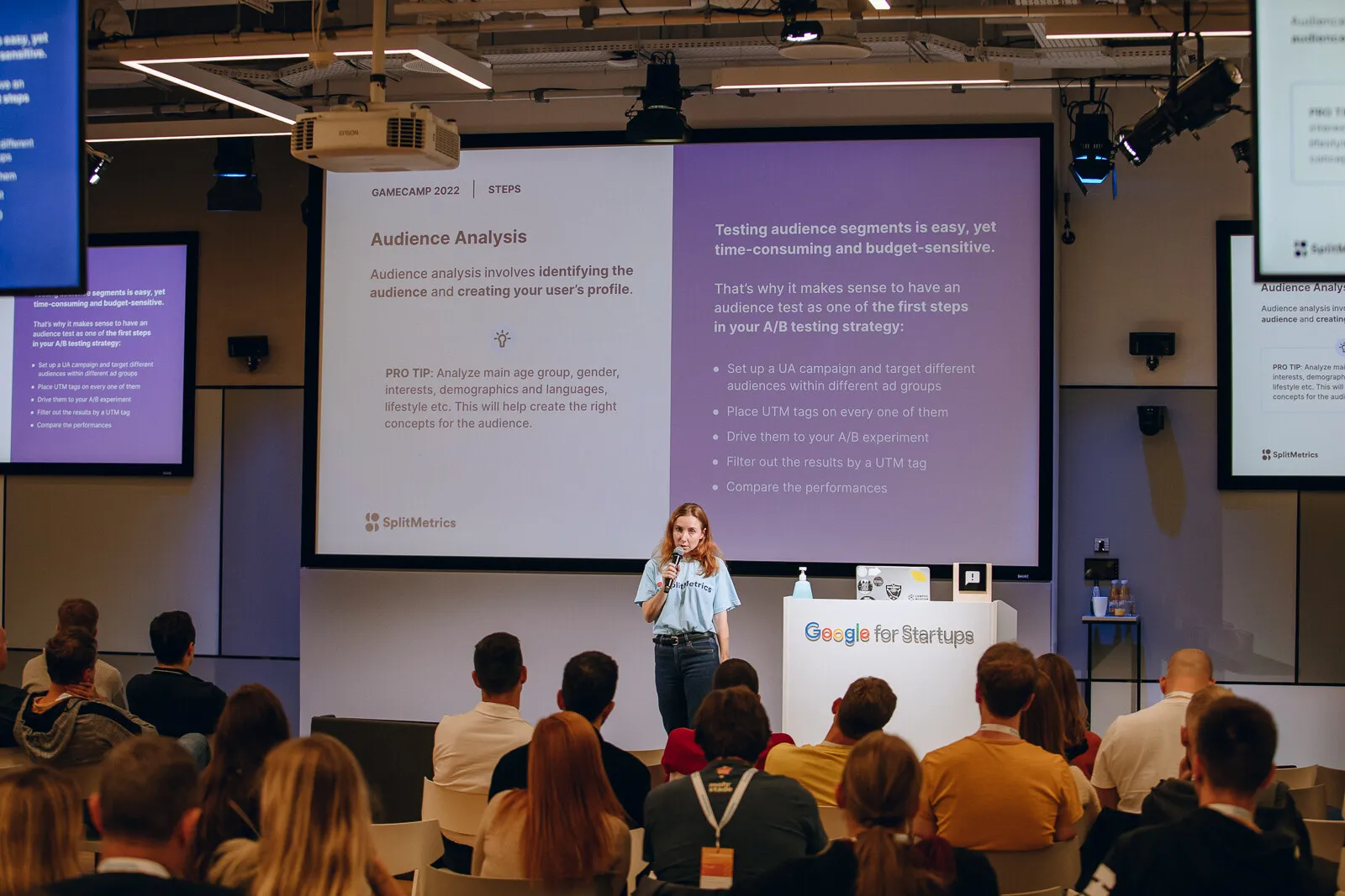 Nadia presenting at Gamecamp 2022, viewed from the audience